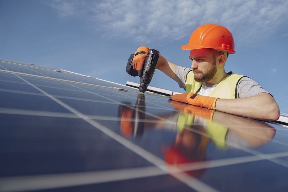 Solar panel installer working on a residential roof